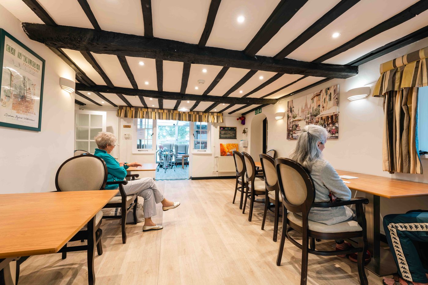 Residents sharing a meal together around the dining table at Little Brook House